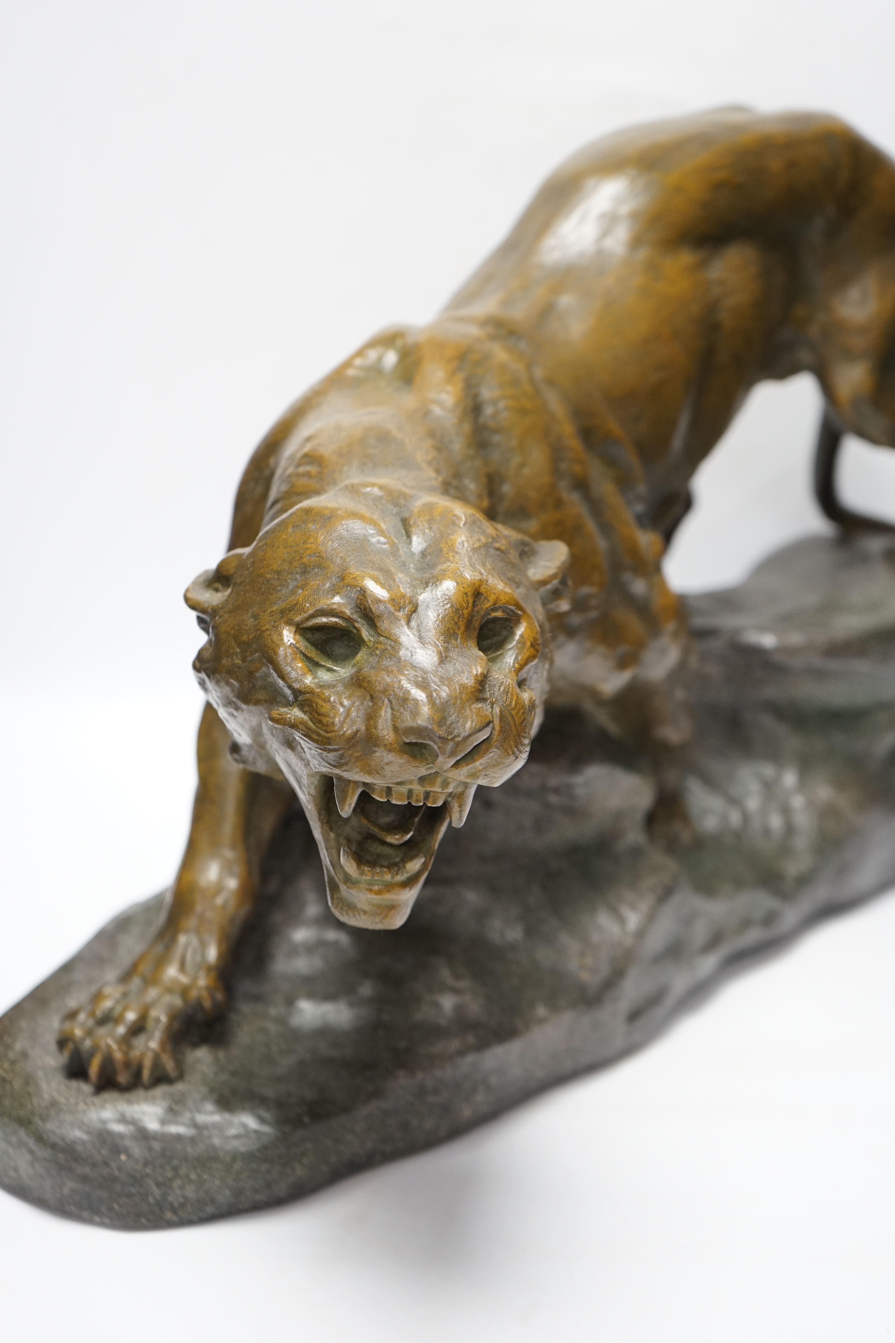 A patinated spelter model of a panther, signed Cartier, approx. 62cm wide